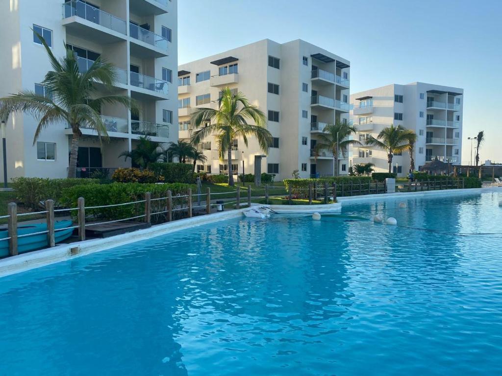 a swimming pool in front of some apartment buildings at Vacacional Bluú Hábitat Lagoons in Los Cerritos