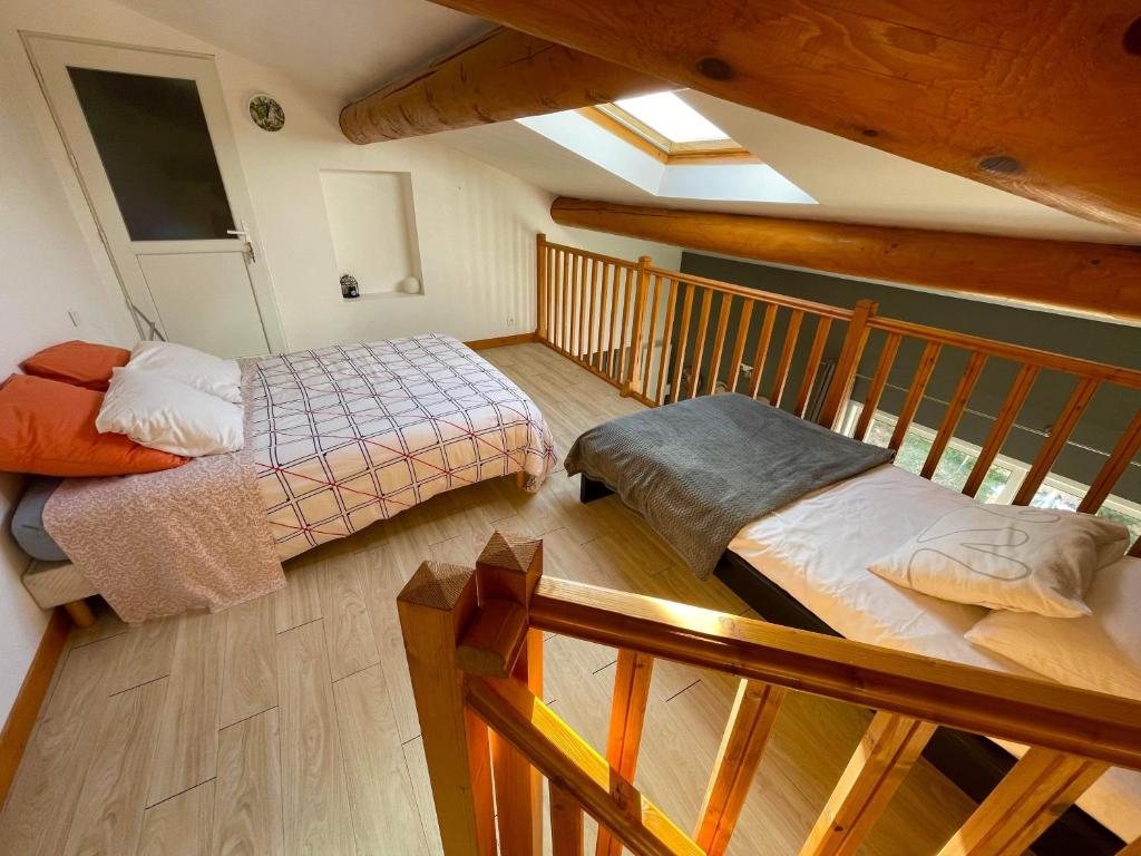 a room with two beds in a attic at Appartement Cosy avec extérieur au calme in Rocbaron