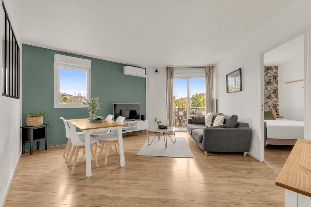 a living room with a couch and a table at ღ Bartavelles - FREE Parking at 4min Blagnac Airport in Blagnac
