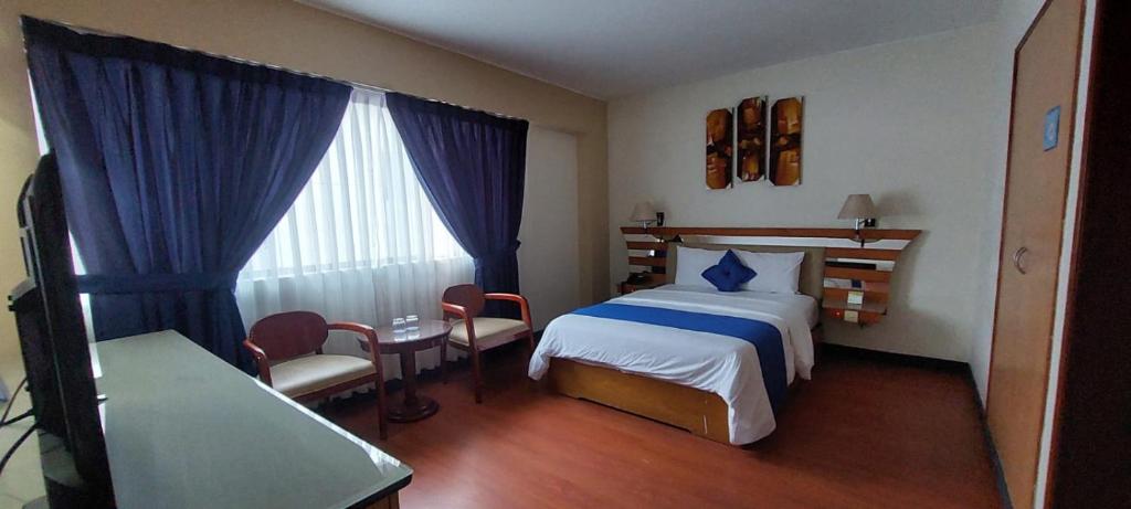 Postel nebo postele na pokoji v ubytování Blue Star Hotel