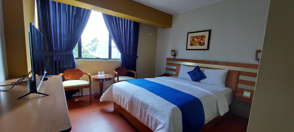 Postel nebo postele na pokoji v ubytování Blue Star Hotel