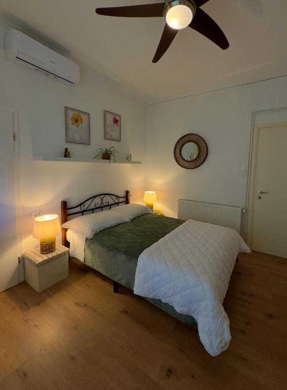a bedroom with a bed and a ceiling fan at Apartman Vasanija in Opatija