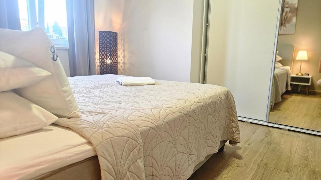 Posteľ alebo postele v izbe v ubytovaní Eximius Apartment