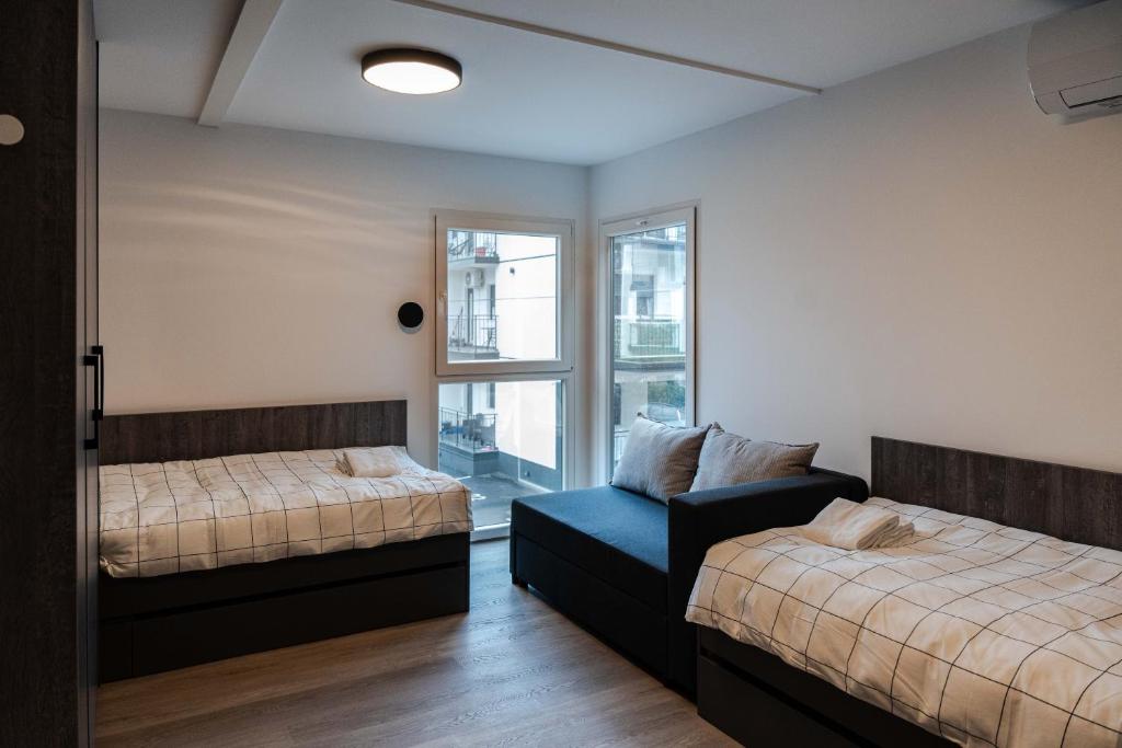 Postel nebo postele na pokoji v ubytování REAL Suites