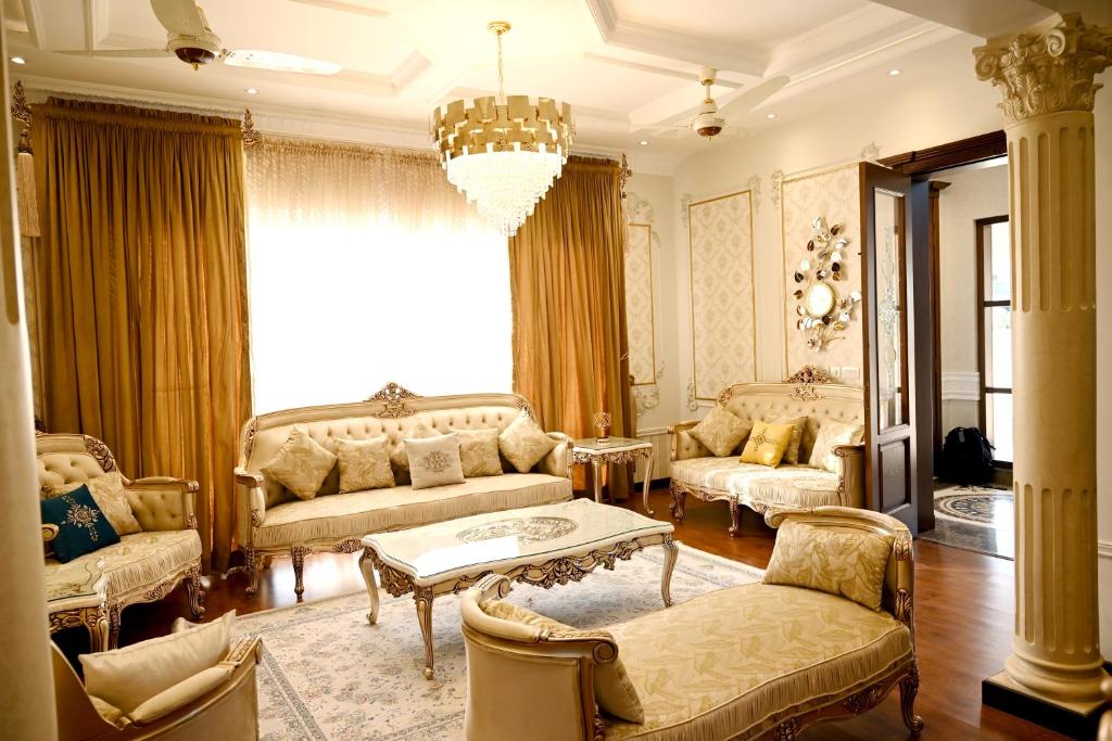 a living room with furniture and a chandelier at Luxury Spanish Villa Close to Raya Fairways Commercial in Lahore