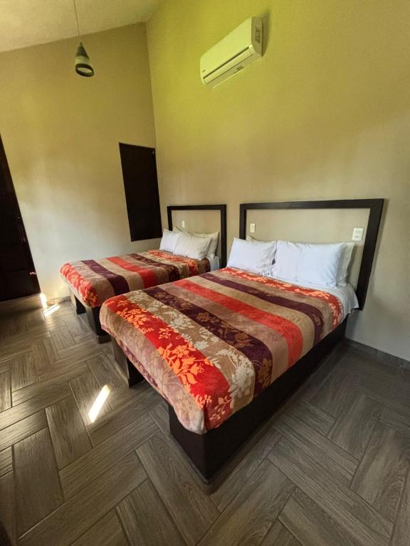 Postel nebo postele na pokoji v ubytování Hotel Real Campestre Tepetoci