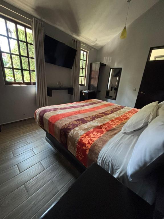 Postel nebo postele na pokoji v ubytování Hotel Real Campestre Tepetoci