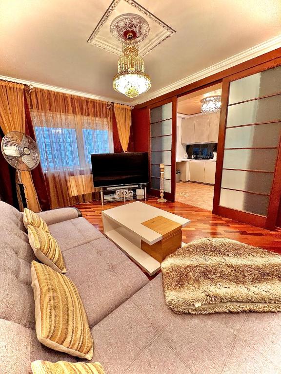 a living room with a couch and a table at Exclusive Golden Sands apartment in Riga