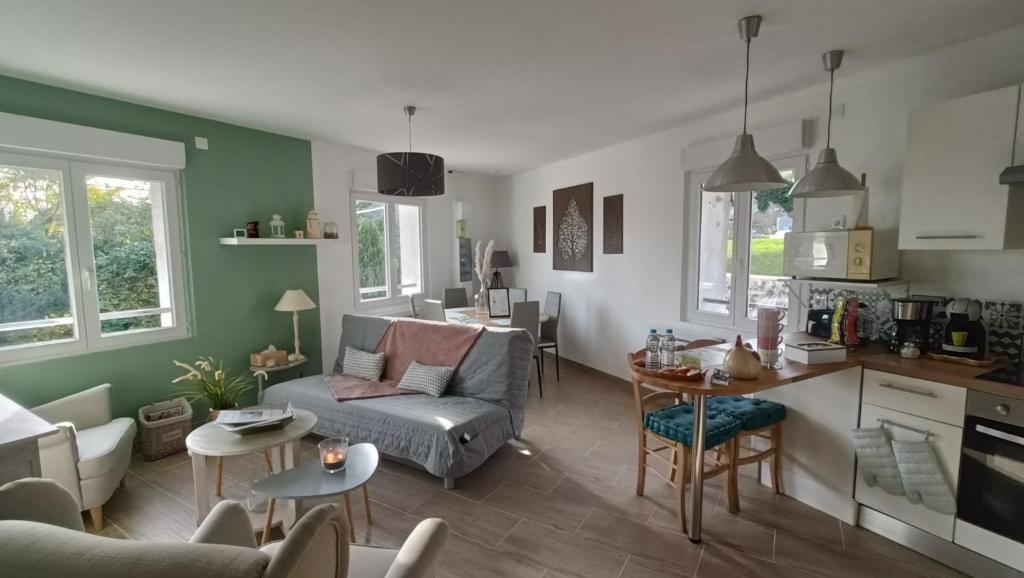 a living room with a couch and a table at Les petites bulles in Coupru