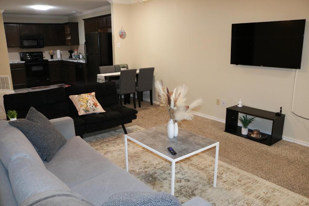 a living room with a couch and a table at Lubbock haven Rooms with individual Bathrooms in Lubbock