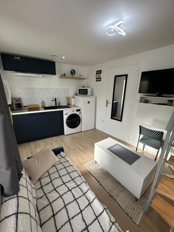 un salon avec un canapé blanc et une cuisine dans l'établissement Belle Maison de ville neuve, à Angers