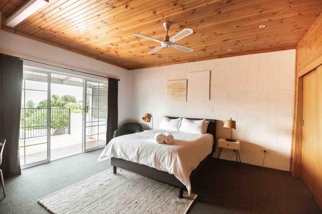 a bedroom with a bed and a ceiling fan at Central Two Bedroom Apartment With Mountain Views in Mount Beauty