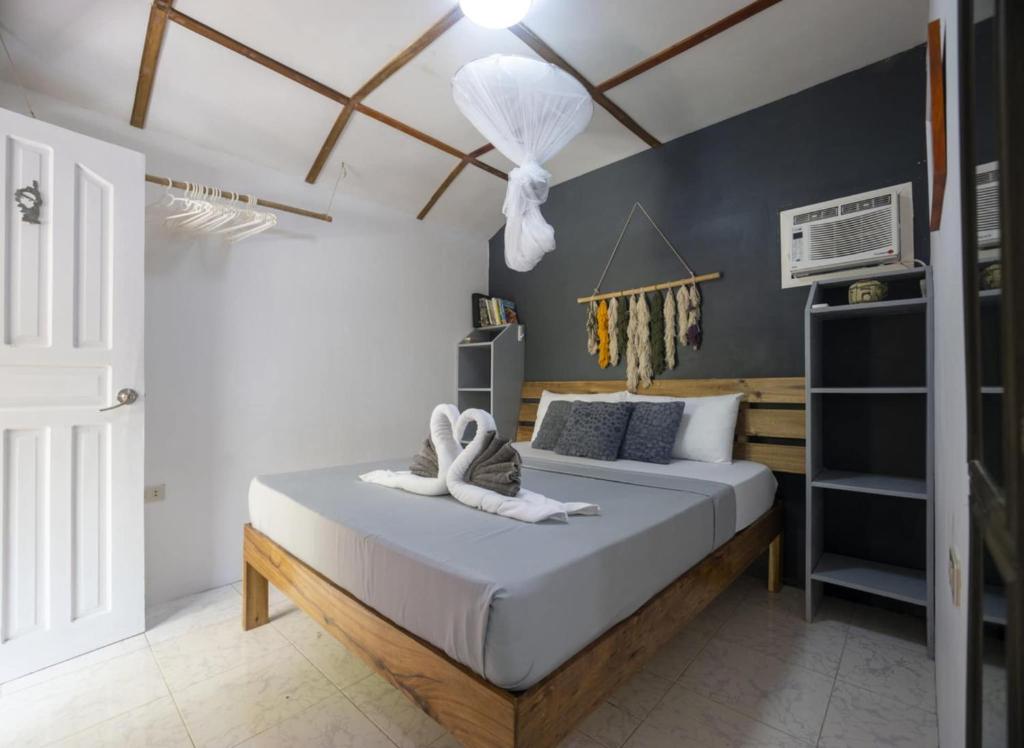 a bedroom with a bed with two towels on it at Bungalow in El Nido