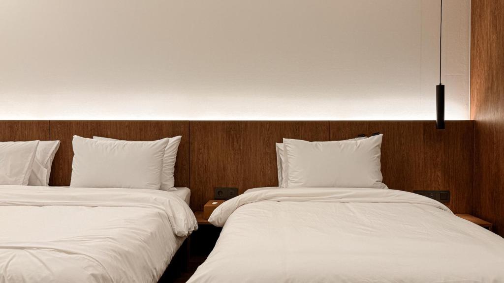 Postel nebo postele na pokoji v ubytování Hotel Yimok
