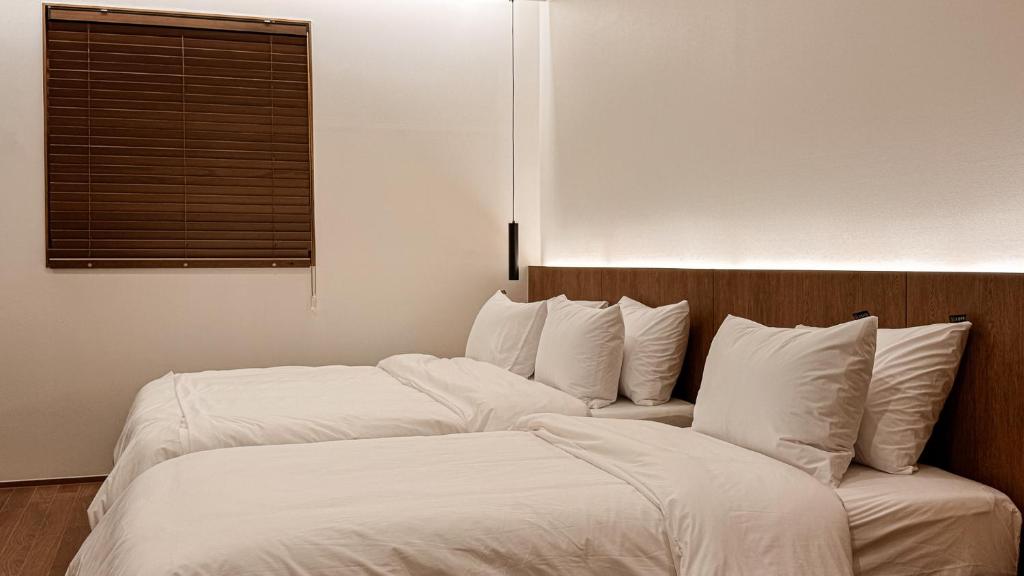 Postel nebo postele na pokoji v ubytování Hotel Yimok
