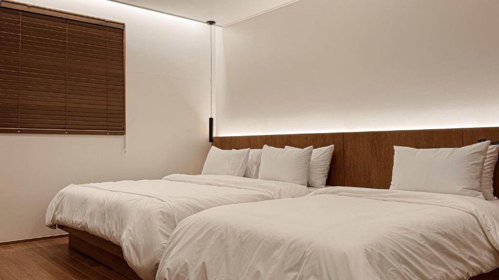 Postel nebo postele na pokoji v ubytování Hotel Yimok