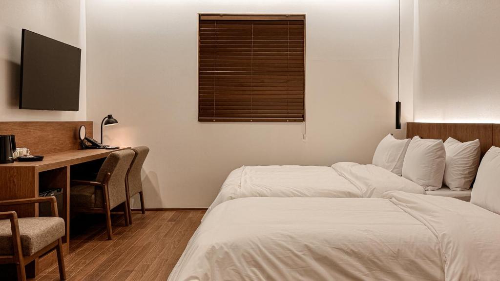 Postel nebo postele na pokoji v ubytování Hotel Yimok