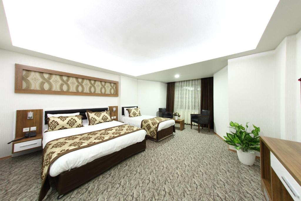 Postel nebo postele na pokoji v ubytování Afyon Grand Arı Hotel
