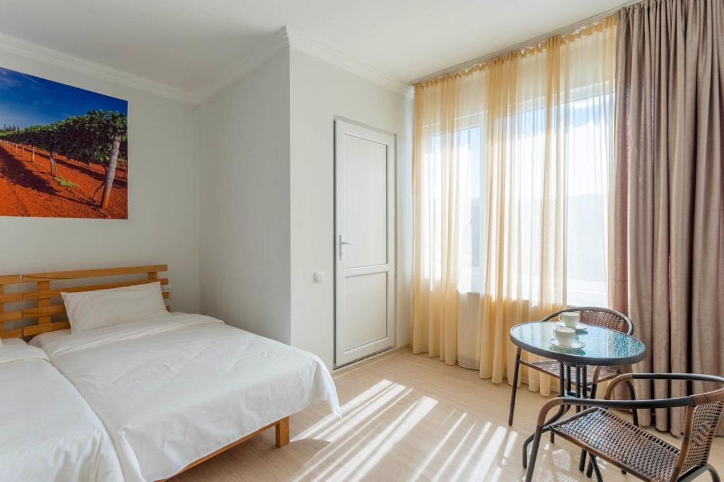 Postel nebo postele na pokoji v ubytování Hotel Tato & CoWorking space