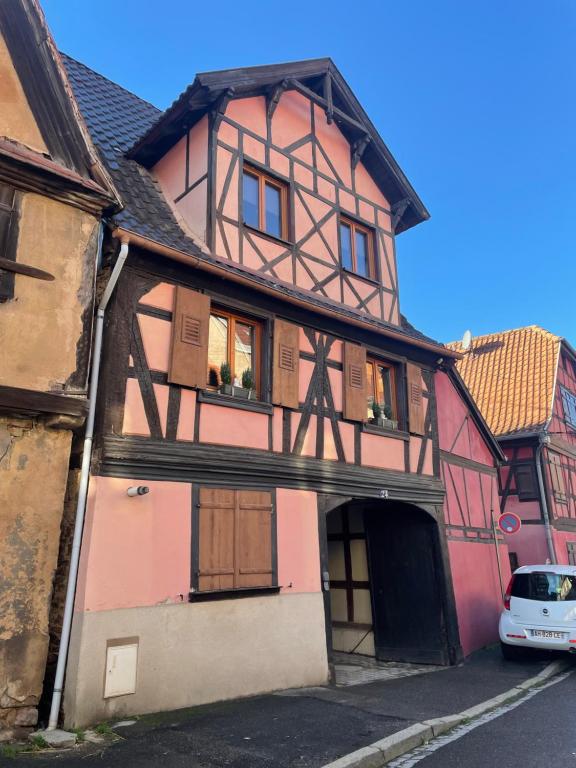 une vieille maison avec une voiture garée devant elle dans l'établissement Maison de charme - 7 personnes - centre ville, à Obernai