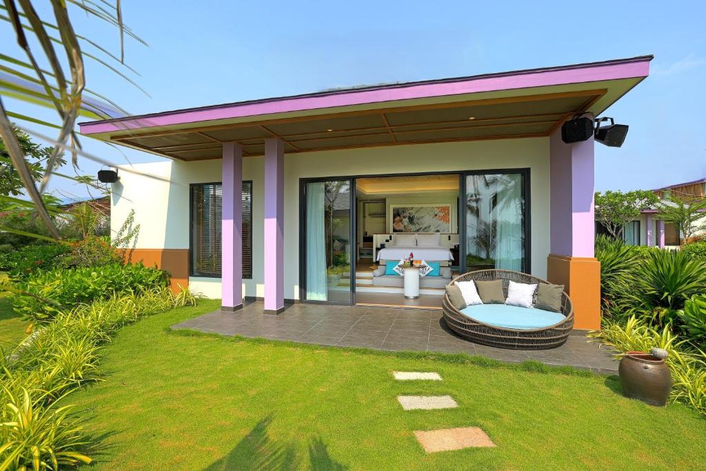 a villa with a pool and a patio at TTC Van Phong Bay Resort - Himalaya Sauna & Steam Retreat Included in Ninh Hòa