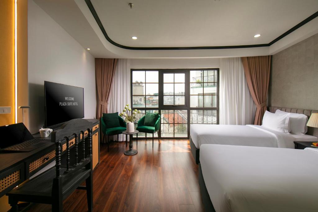 Postel nebo postele na pokoji v ubytování Hanoi Plaza Suite Hotel & Spa