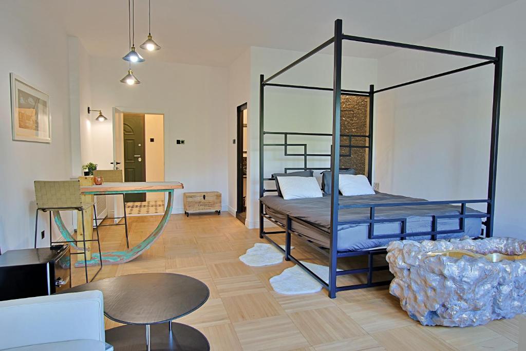 a room with a bed and a table and a couch at Art Boutique Residence in Bucharest