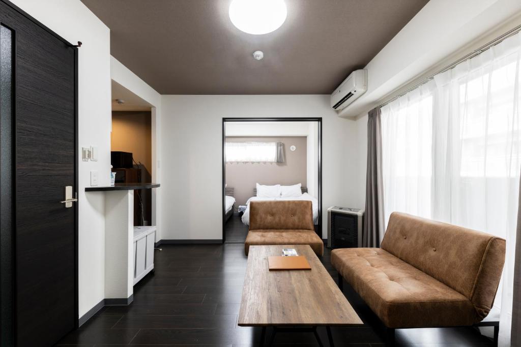 een woonkamer met een bank en een tafel bij Estrella in Sapporo