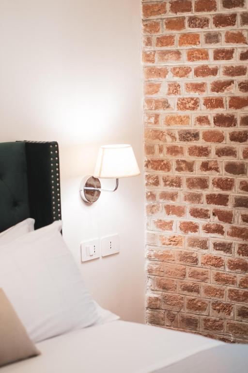 Postel nebo postele na pokoji v ubytování Carlo Felice Boutique Hotel