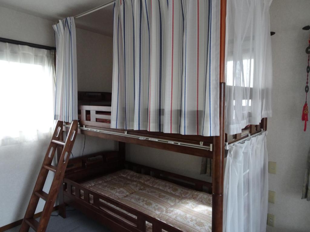 Postel nebo postele na pokoji v ubytování Guesthouse Gifu SUAI
