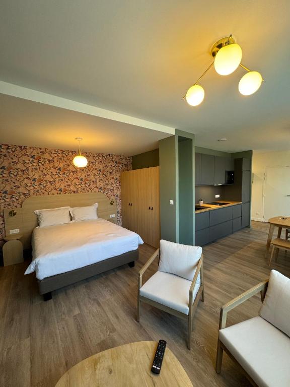 a bedroom with a bed and a living room at Villa Aura in Eu