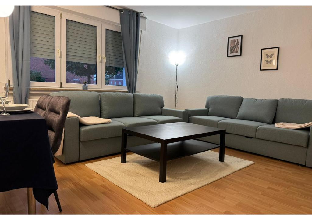 a living room with a couch and a coffee table at Zentrale Wohnung mit Küche & 4 Betten in Oelde Stay Nest in Oelde
