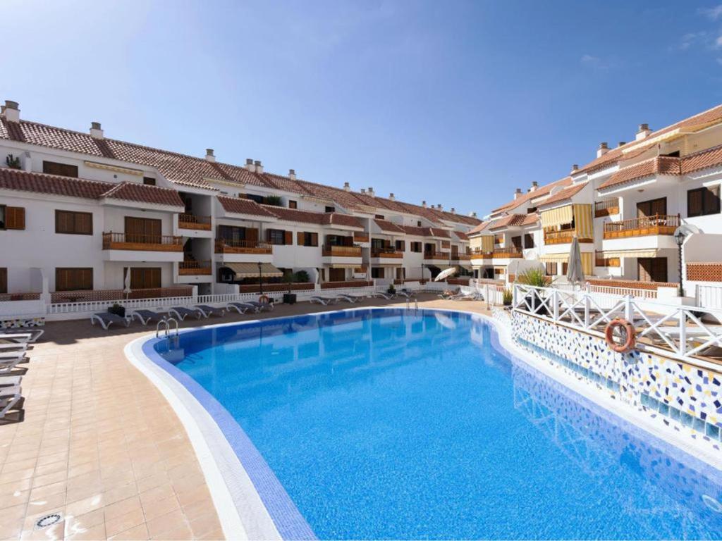 a large swimming pool in front of a hotel at Live Playa las Americas Residencial el Cardon in Arona