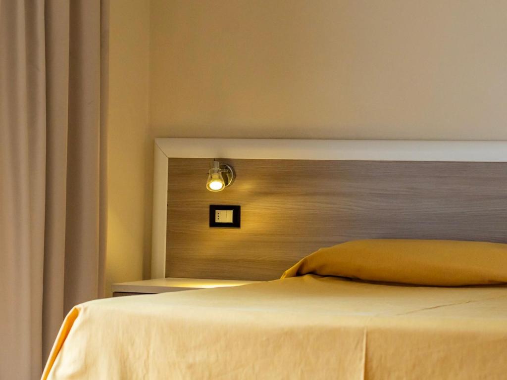 Postel nebo postele na pokoji v ubytování Hotel Fabricia