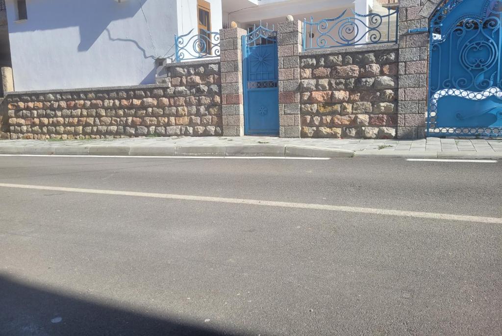 a street with a building with a blue door at Betty's Home in Korçë