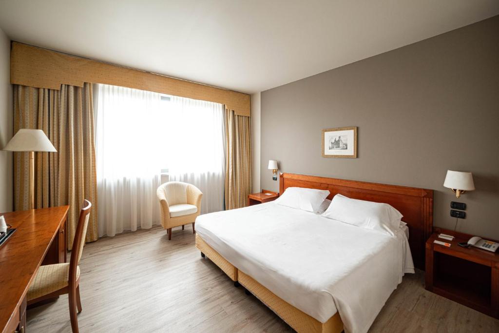 Postel nebo postele na pokoji v ubytování Phi Hotel Cavalieri