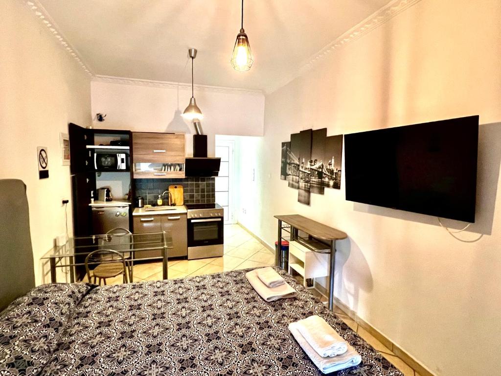 a room with a bed and a flat screen tv at Princeps De Cura Gazi in Athens