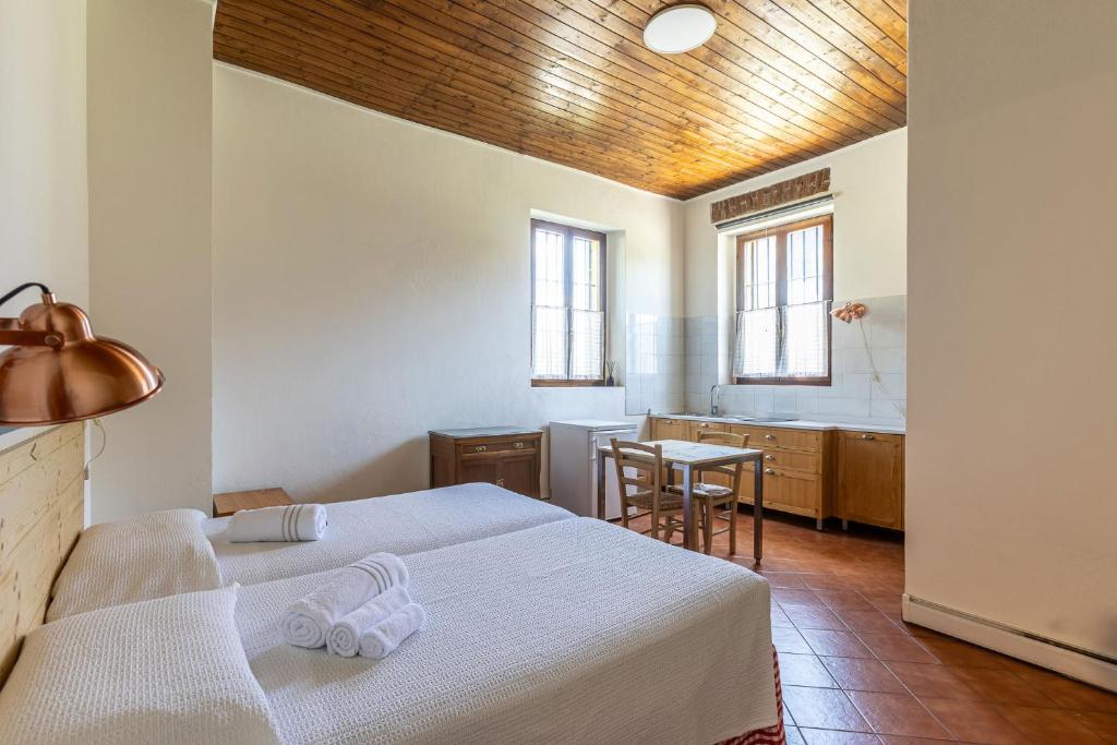 a hotel room with two beds and a bathroom at Cascina Gaggioli in Milan