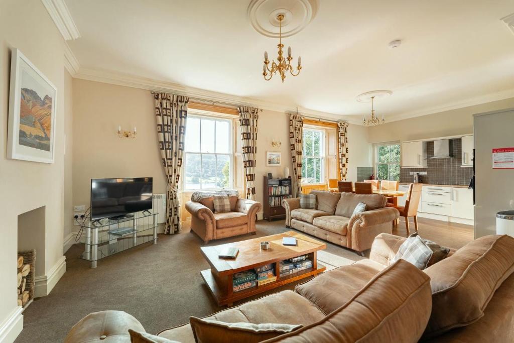 a living room with a couch and a tv at Langdale Crag in Grasmere