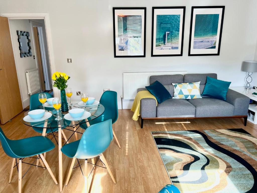 a living room with a couch and a table and chairs at Between the Beach and Shops 2 bath private parking in Portsmouth