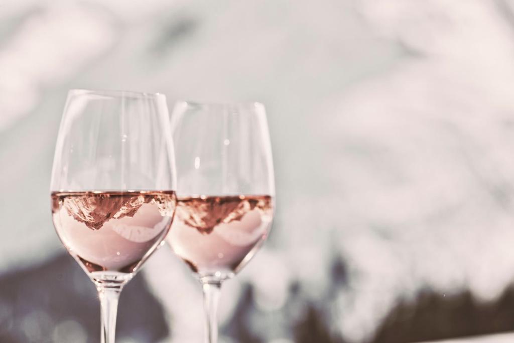 two glasses of white wine sitting next to each other at Hotel Goldener Berg in Lech am Arlberg