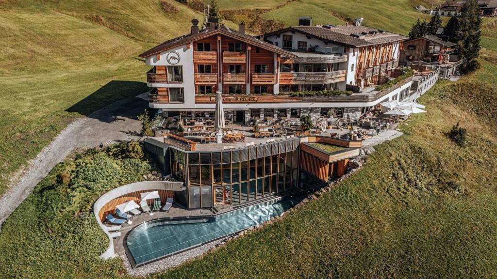 an aerial view of a large building with a pool at Hotel Goldener Berg in Lech am Arlberg