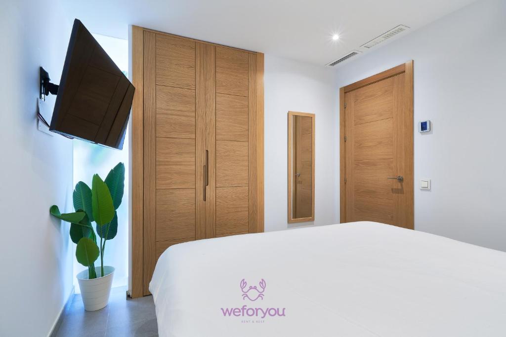 Televízia a/alebo spoločenská miestnosť v ubytovaní weforyou Isla de Poniente 2 Bedrooms and Parking