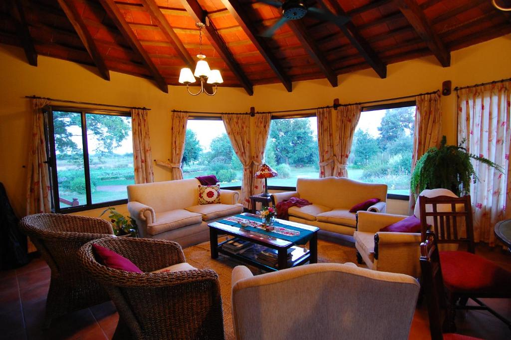 a living room with couches and chairs and a table at Finca Cielo Verde in Chicoana