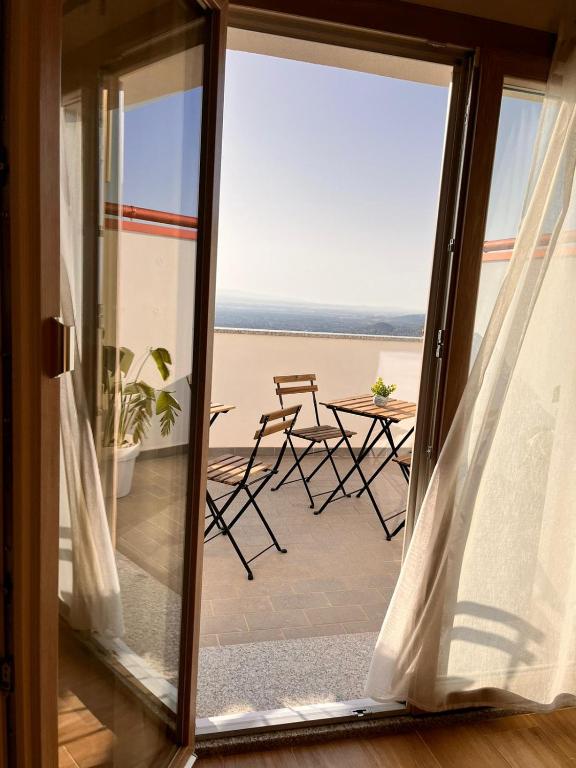 una porta scorrevole in vetro con vista sulla spiaggia di B&B La Panoramica a Villacidro