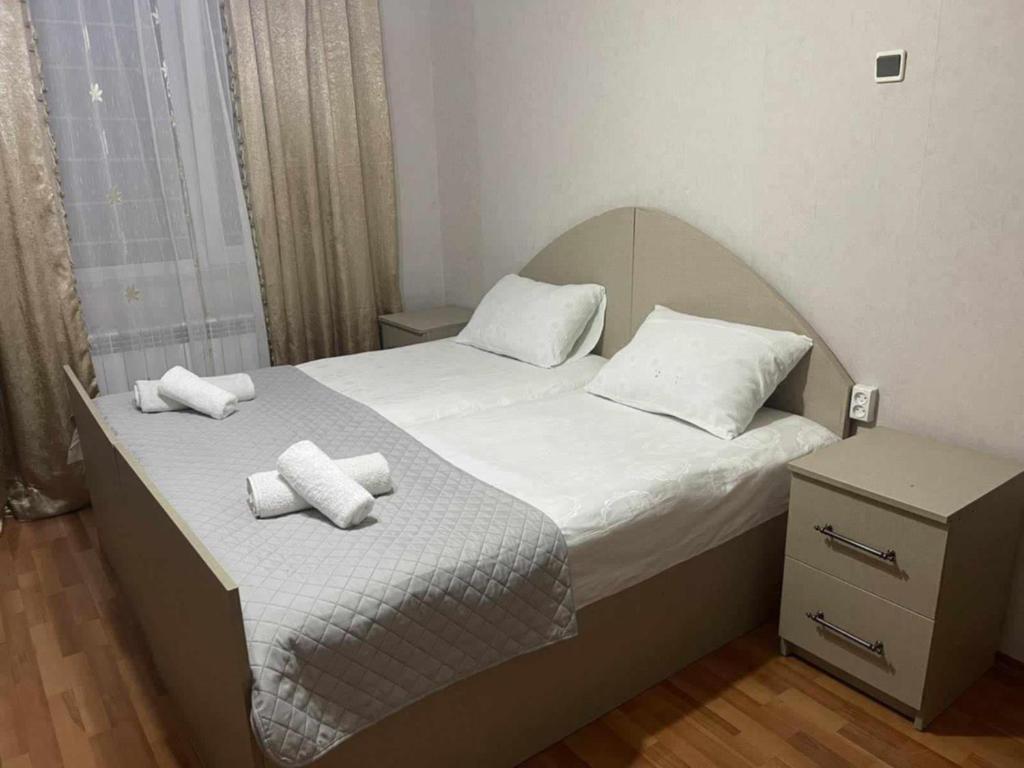 a bedroom with two beds with white sheets and pillows at Paata in Kutaisi