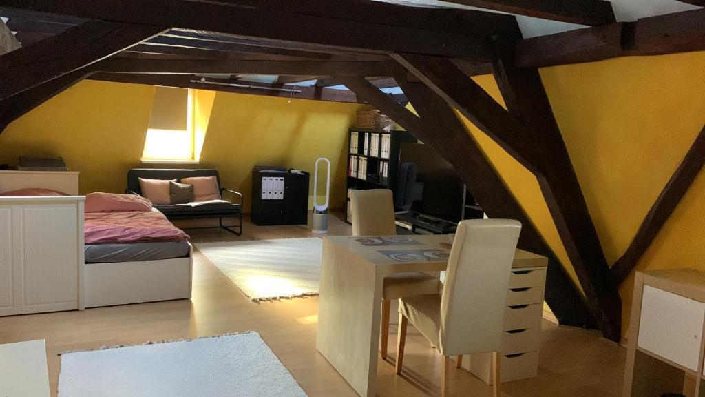 a bedroom with a bed and a table and chairs at Altstadtblick in Bad Kreuznach