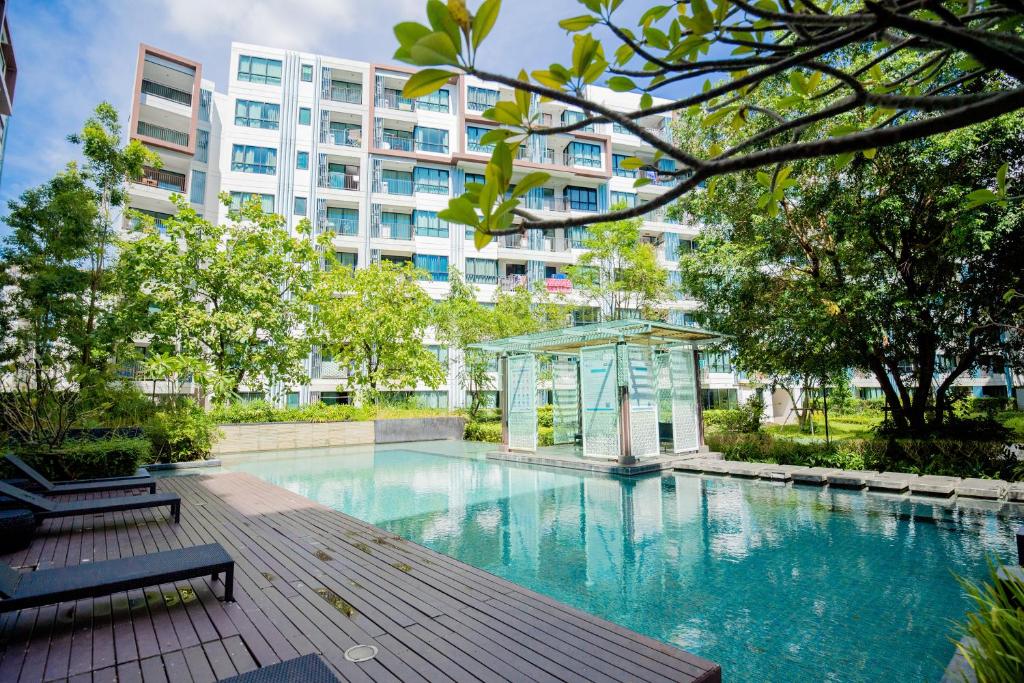 a swimming pool in front of a building at 02Nice room phuket town near Shopping Malls and Naka night market in Phuket Town