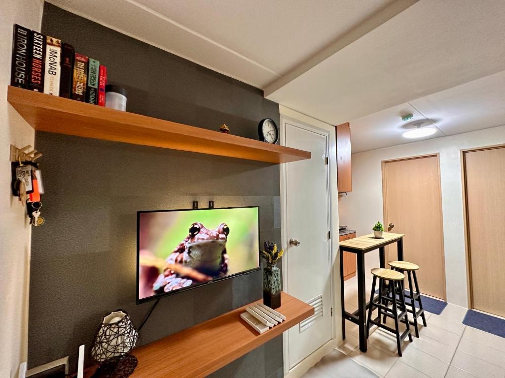 a living room with a flat screen tv on a wall at VR Homes Ortigas - 2BR Condo with Free WiFi in Manila