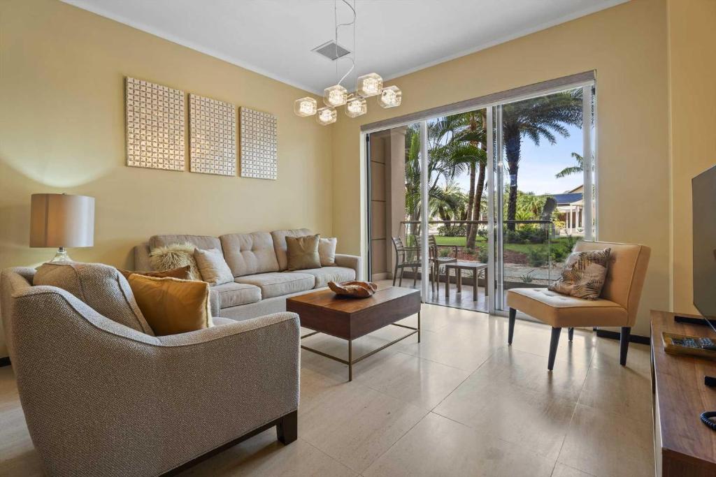 a living room with a couch and a table at Eagle Beach- Best 2BR rates at LeVent Resort-LV105 in Palm-Eagle Beach
